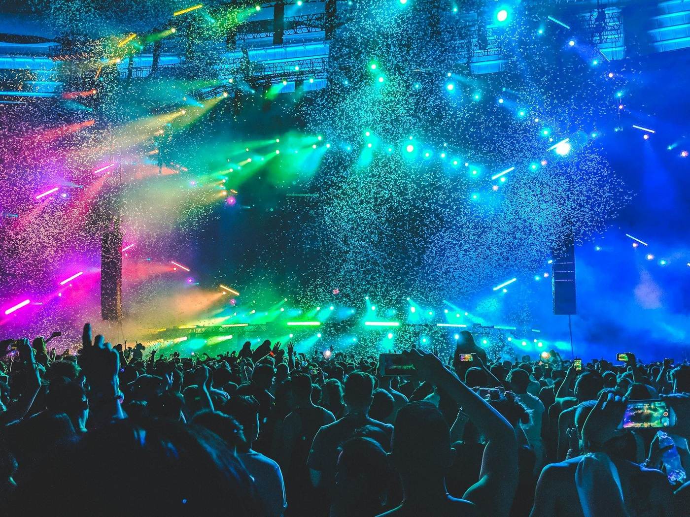 Crowd at a nightlife venue with phones raised toward the stage
