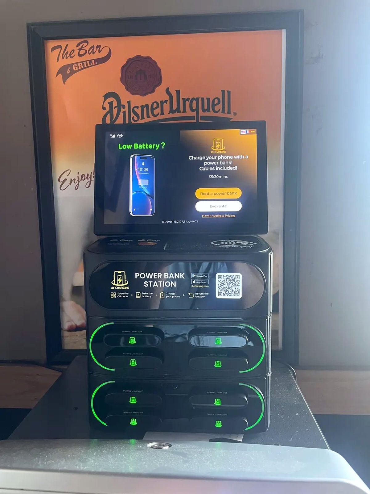 Power-bank rental station on a bar counter