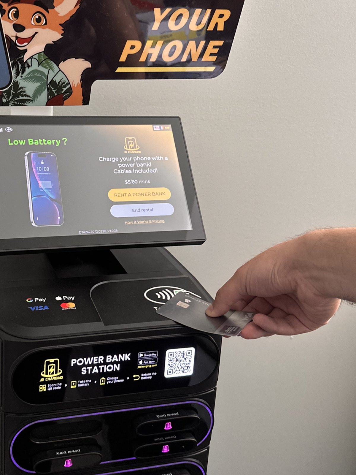 Hand tapping the station reader to unlock a power bank
